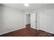 This bedroom features a spacious closet and beautiful hardwood floors at 4132 Kenton Glenn Nw Ct, Concord, NC 28027