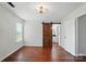 Bedroom featuring a barn door to ensuite bath, wood-look floors, and natural light at 4132 Kenton Glenn Nw Ct, Concord, NC 28027