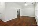 Bright living room with hardwood floors, view of kitchen, and large windows for plenty of natural light at 4132 Kenton Glenn Nw Ct, Concord, NC 28027
