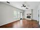 Living room features hardwood flooring, brick fireplace, and lots of natural light from the windows at 4132 Kenton Glenn Nw Ct, Concord, NC 28027