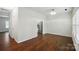 Spacious living room featuring hardwood floors, and view to kitchen area with stainless steel refrigerator at 4132 Kenton Glenn Nw Ct, Concord, NC 28027