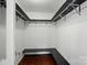 Walk-in closet with shelves, hanging rods, and bench. Lots of storage at 4132 Kenton Glenn Nw Ct, Concord, NC 28027