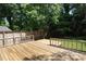 Backyard features an expansive wooden deck, lush lawn, and shade trees at 4361 Applegate Rd, Charlotte, NC 28209