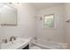 Bright bathroom features tiled walls, vanity with sink, and a shower-tub combination at 4361 Applegate Rd, Charlotte, NC 28209
