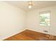 Comfortable bedroom with ceiling fan, wood floors, and bright, sunlit window at 4361 Applegate Rd, Charlotte, NC 28209