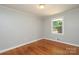Bright bedroom with hardwood floors, neutral walls, and a sunlit window at 4361 Applegate Rd, Charlotte, NC 28209