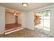 Breakfast nook featuring tile floor, access to the deck, and view into the dining room at 4361 Applegate Rd, Charlotte, NC 28209