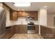 Updated kitchen featuring stainless steel appliances, granite countertops, and wooden cabinets at 4361 Applegate Rd, Charlotte, NC 28209