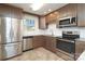 Well-lit kitchen with modern stainless-steel appliances and classic wood cabinetry at 4361 Applegate Rd, Charlotte, NC 28209