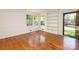 Bright living room with hardwood floors, built-in shelving, and large windows overlooking the yard at 4361 Applegate Rd, Charlotte, NC 28209