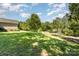 Expansive backyard with a well-manicured lawn, mature trees, and a view of the neighborhood at 4405 Sugar Cane Ct, Waxhaw, NC 28173