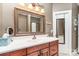 Bathroom vanity with a framed mirror, lighting, tissue box, and countertop accessories at 4405 Sugar Cane Ct, Waxhaw, NC 28173