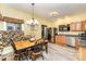 Well-lit dining area with a table set for four, alongside updated kitchen appliances and stylish decor at 4405 Sugar Cane Ct, Waxhaw, NC 28173