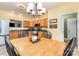 Charming kitchen with wood cabinets, granite countertops, and an adjacent dining area for Gathering meals at 4405 Sugar Cane Ct, Waxhaw, NC 28173