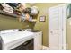 Well-organized laundry room with modern washer and dryer, ample shelving, and neutral-toned flooring at 4405 Sugar Cane Ct, Waxhaw, NC 28173