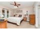 Serene bedroom with neutral tones, a ceiling fan, and natural light from the large window at 4405 Sugar Cane Ct, Waxhaw, NC 28173