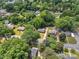 This aerial shot shows a residential neighborhood with tree-lined streets and well-maintained homes at 4553 Morgan St, Charlotte, NC 28208