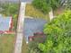 Bird's-eye view of the house showing the roof, driveway, yard with mature trees and proximity to neighboring houses at 4553 Morgan St, Charlotte, NC 28208