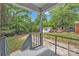 A large, enclosed backyard with mature trees and a storage building at 4553 Morgan St, Charlotte, NC 28208