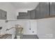 Basement area perfect for storage with cabinets and painted concrete floors at 4553 Morgan St, Charlotte, NC 28208