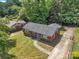 Aerial view of a brick house with a paved walkway and driveway and well maintained front yard at 4553 Morgan St, Charlotte, NC 28208