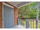 Inviting front porch featuring brick accents, gray trim, and a view of the yard at 4553 Morgan St, Charlotte, NC 28208