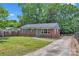 Classic brick house with a driveway and a green lawn, perfect for suburban living at 4553 Morgan St, Charlotte, NC 28208