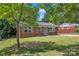 Well-maintained brick home with lush green lawn and trees, offering great curb appeal at 4553 Morgan St, Charlotte, NC 28208
