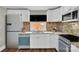 Modern kitchen features white cabinets, stainless appliances, and stylish backsplash at 4553 Morgan St, Charlotte, NC 28208