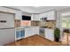 Bright kitchen with white cabinets, stainless steel appliances, and hardwood floors at 4553 Morgan St, Charlotte, NC 28208