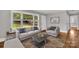 Inviting living room featuring neutral tones, hardwood floors, and a large window at 4553 Morgan St, Charlotte, NC 28208