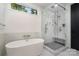 Elegant bathroom showcasing a freestanding tub, walk-in glass shower with a seat, and a window for natural light at 4608 Rockwood Dr, Waxhaw, NC 28173