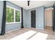 Bedroom featuring hardwood floors, a large window with green views, and black trim at 4608 Rockwood Dr, Waxhaw, NC 28173
