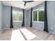 Light-filled bedroom with hardwood floors, two windows, and black out curtains at 4608 Rockwood Dr, Waxhaw, NC 28173