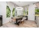 Dining room with wood table, modern chandelier, and bright windows overlooking greenery at 4608 Rockwood Dr, Waxhaw, NC 28173
