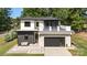 Striking two-story home featuring white and gray facade, modern garage door, and second story balcony at 4608 Rockwood Dr, Waxhaw, NC 28173