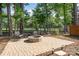 Cozy outdoor fire pit area with paver patio, seating, and lush greenery, perfect for entertaining at 4608 Rockwood Dr, Waxhaw, NC 28173