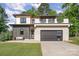 Beautiful modern home with a two-car garage, sleek design elements, and well-manicured lawn at 4608 Rockwood Dr, Waxhaw, NC 28173