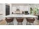 Kitchen island with white countertops and three brown upholstered chairs at 4608 Rockwood Dr, Waxhaw, NC 28173