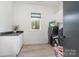 Bright laundry room with modern washer and dryer, sleek countertops, and ample storage space at 4608 Rockwood Dr, Waxhaw, NC 28173