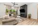 Bright living room with fireplace, ceiling fan, hardwood floors and large glass doors to outside at 4608 Rockwood Dr, Waxhaw, NC 28173