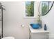 Stylish powder room with blue glass bowl sink and modern fixtures at 4608 Rockwood Dr, Waxhaw, NC 28173