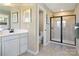 Bathroom with a walk-in shower, single vanity sink, and neutral tile flooring at 511 Lenswood Ct, Denver, NC 28037