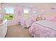 Pink bedroom featuring two twin beds with white frames and matching unicorn-themed decor and plush bedding at 511 Lenswood Ct, Denver, NC 28037