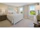 Bright bedroom featuring a bed with white linens, complemented by coordinating furniture and natural light from two windows at 511 Lenswood Ct, Denver, NC 28037