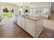 Open-concept kitchen island with sink, dishwasher, and hardwood flooring, perfect for entertaining at 511 Lenswood Ct, Denver, NC 28037