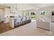 Open-concept kitchen with a large island, breakfast bar, and seamless flow to the living area at 511 Lenswood Ct, Denver, NC 28037