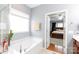 Bright bathroom with a soaking tub, a view to bedroom, and a separate glass shower at 52538 Winchester St, Fort Mill, SC 29707