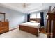 Spacious bedroom with ceiling fan, natural light, wood floors and ensuite bathroom at 52538 Winchester St, Fort Mill, SC 29707