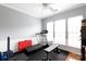 Bright exercise room featuring a treadmill, weight bench, and neutral gray walls at 52538 Winchester St, Fort Mill, SC 29707